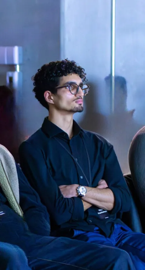 Mina in a candid moment — moody blue lighting, thoughtful gaze