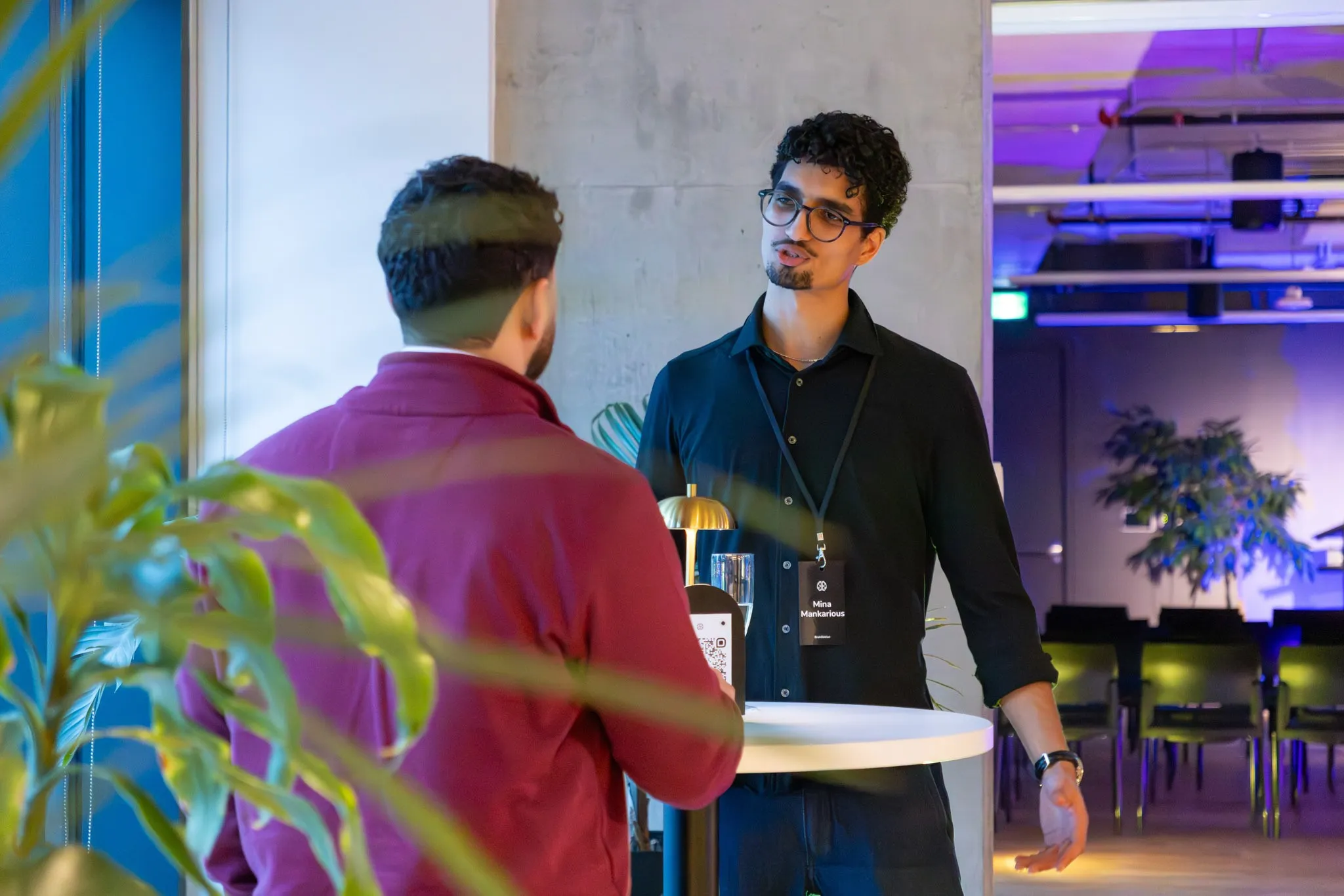 Mina at a networking event, in conversation with fellow founders